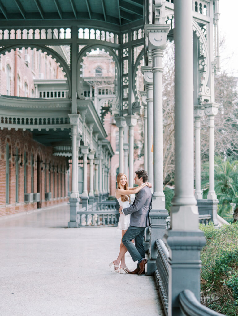 Romantic pose beneath historic arches in downtown Florida engagement shoot