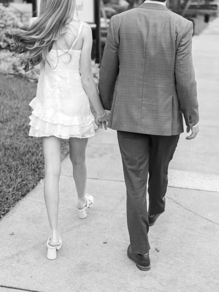 Romantic golden hour stroll through lush greenery in Florida engagement shoot